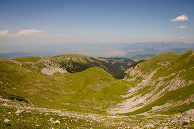 Scenic view of green landscape against sky