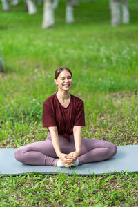 Full length of man sitting on grass