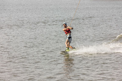 Man kite boarding in river