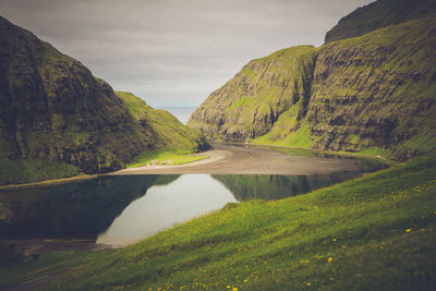 Scenic view of lake and mountains against sky