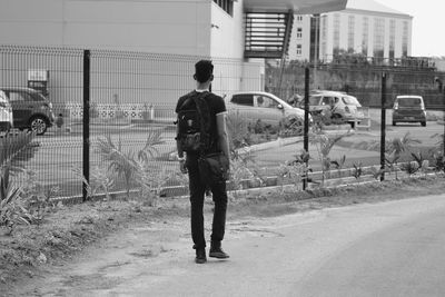 Full length of man standing on road in city