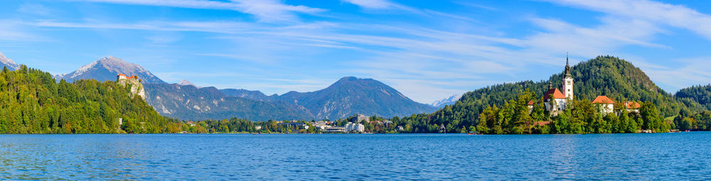 Panoramic view of trees and mountain against cloudy sky