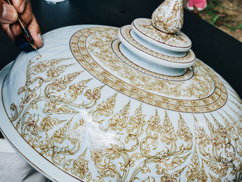 High angle view of person preparing food in plate on table