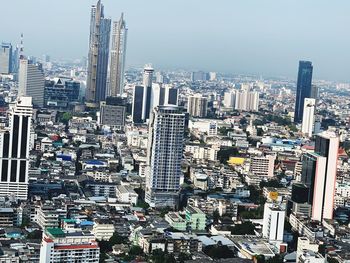 High angle view of modern buildings in city against sky