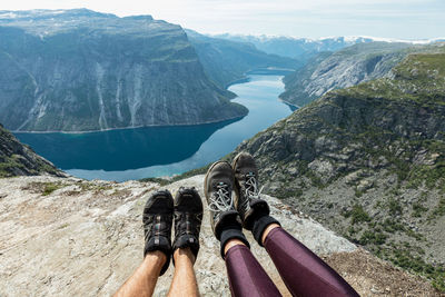 Low section of people on rocks against mountains