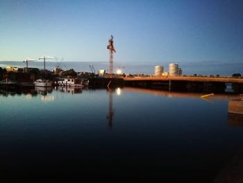 Factory by buildings against clear sky