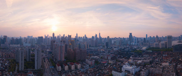 High angle view of modern buildings against sky during sunset