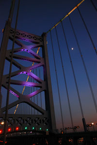Low angle view of illuminated bridge against sky