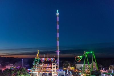 Illuminated ferris wheel at night