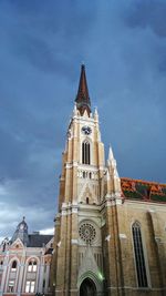 Low angle view of bell tower against sky