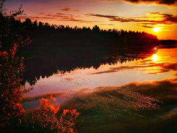 Scenic view of silhouette trees against romantic sky at sunset