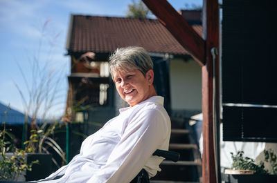 Senior woman enjoys a moment of tranquility in her wheelchair with mountain views