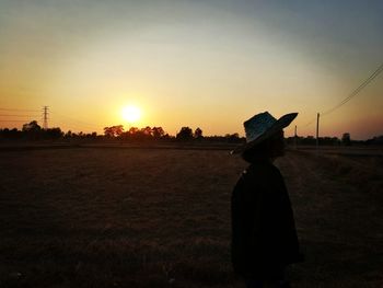 Rear view of man at sunset