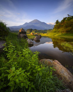 Scenic view of lake and mountains against sky