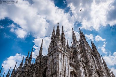 Low angle view of milan cathedral against cloudy sky