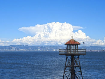 Lifeguard hut by sea against sky