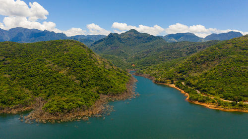 A beautiful lake among the mountains with a green forest. kalu ganga reservoir, sri lanka.