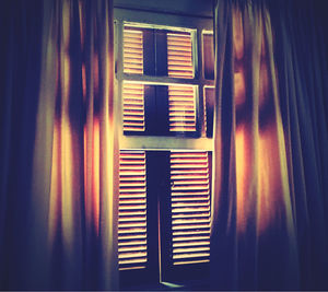 Close-up of woman standing by window at home