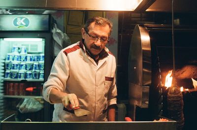 Full length of a man standing in kitchen