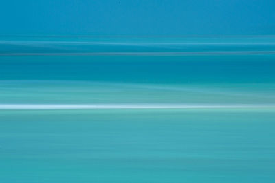 Scenic view of sea against blue sky