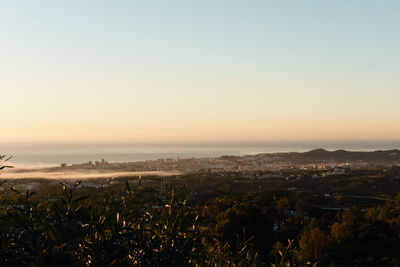 Scenic view of sea against clear sky during sunset