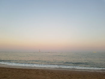 Scenic view of sea against clear sky during sunset