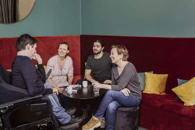 Smiling coworkers talking together