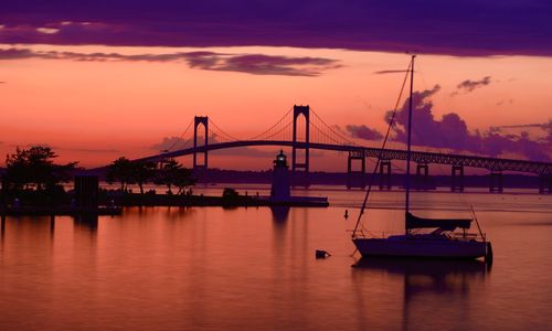 View of bridge over river at sunset