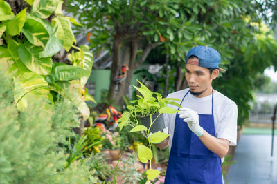Young man working on plant