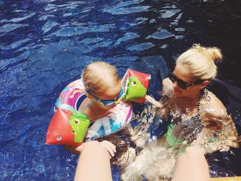 High angle view of family enjoying summer in swimming pool