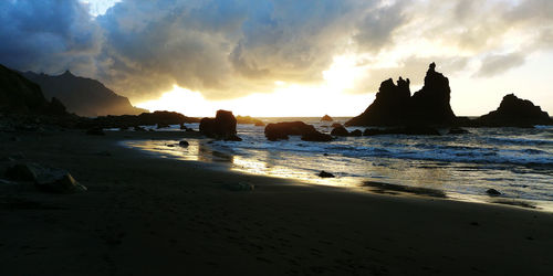 Scenic view of beach against sky during sunset