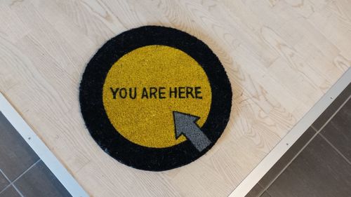 High angle view of doormat on floorboard