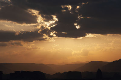 Scenic view of silhouette mountains against sky during sunset