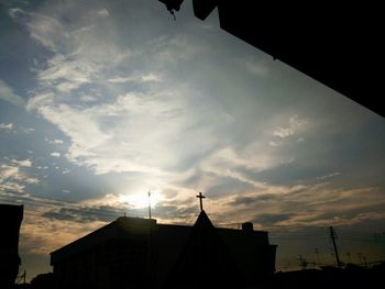 High section of building against sky at sunset