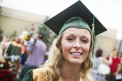 Portrait of woman with mortarboard at graduation ceremony