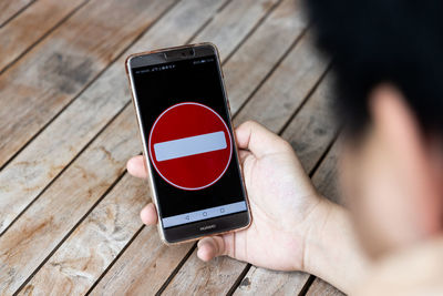 Midsection of person holding mobile phone