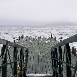 Pier over sea against clear sky