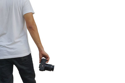 Midsection of man photographing against white background