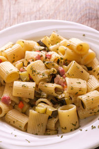 Rigatoni pasta with bacon and zucchini