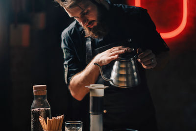 Barista making coffee on table