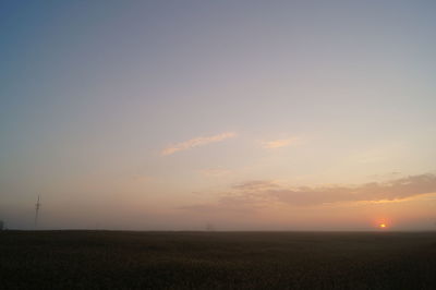 Scenic view of field against sky during sunrise