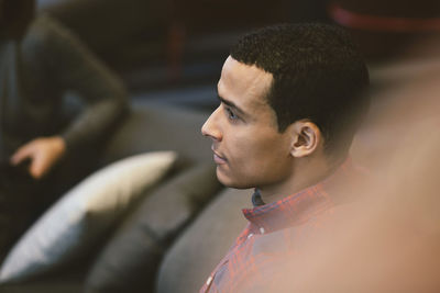 Businessman with colleague listening in meeting at office