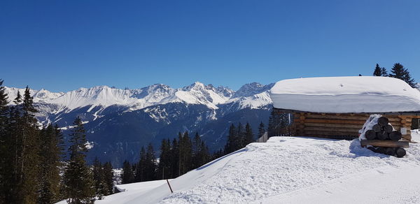 Snow covered mountains against clear blue sky