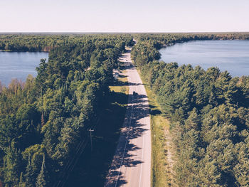 High angle view of trees by river against sky