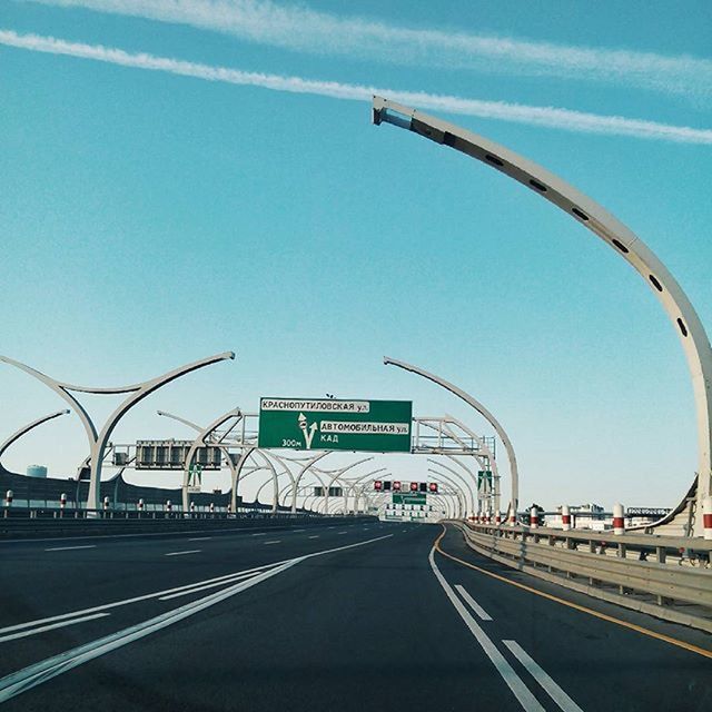 transportation, road, clear sky, road marking, blue, connection, mode of transport, the way forward, car, sky, built structure, highway, land vehicle, communication, street, architecture, diminishing perspective, text, day, no people