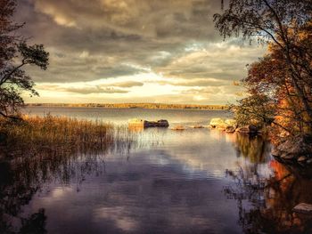 Scenic view of lake against sky during sunset