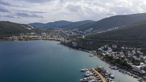 High angle view of townscape by sea against sky