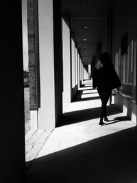 Rear view of woman walking in corridor