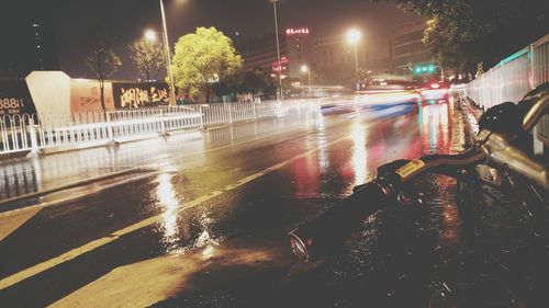 Cars on wet street during rainy season at night