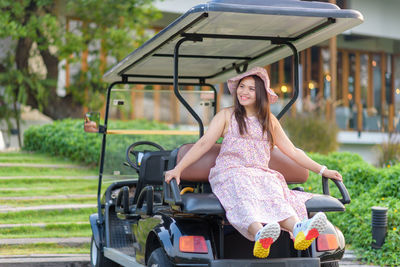 Portrait of smiling woman sitting outdoors